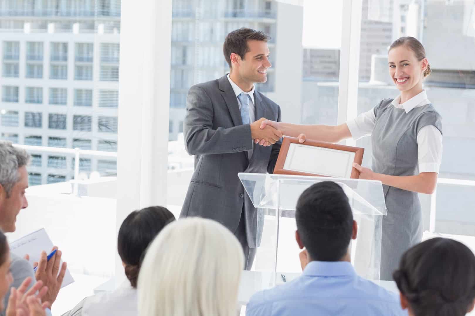 Business people receiving award in meeting room