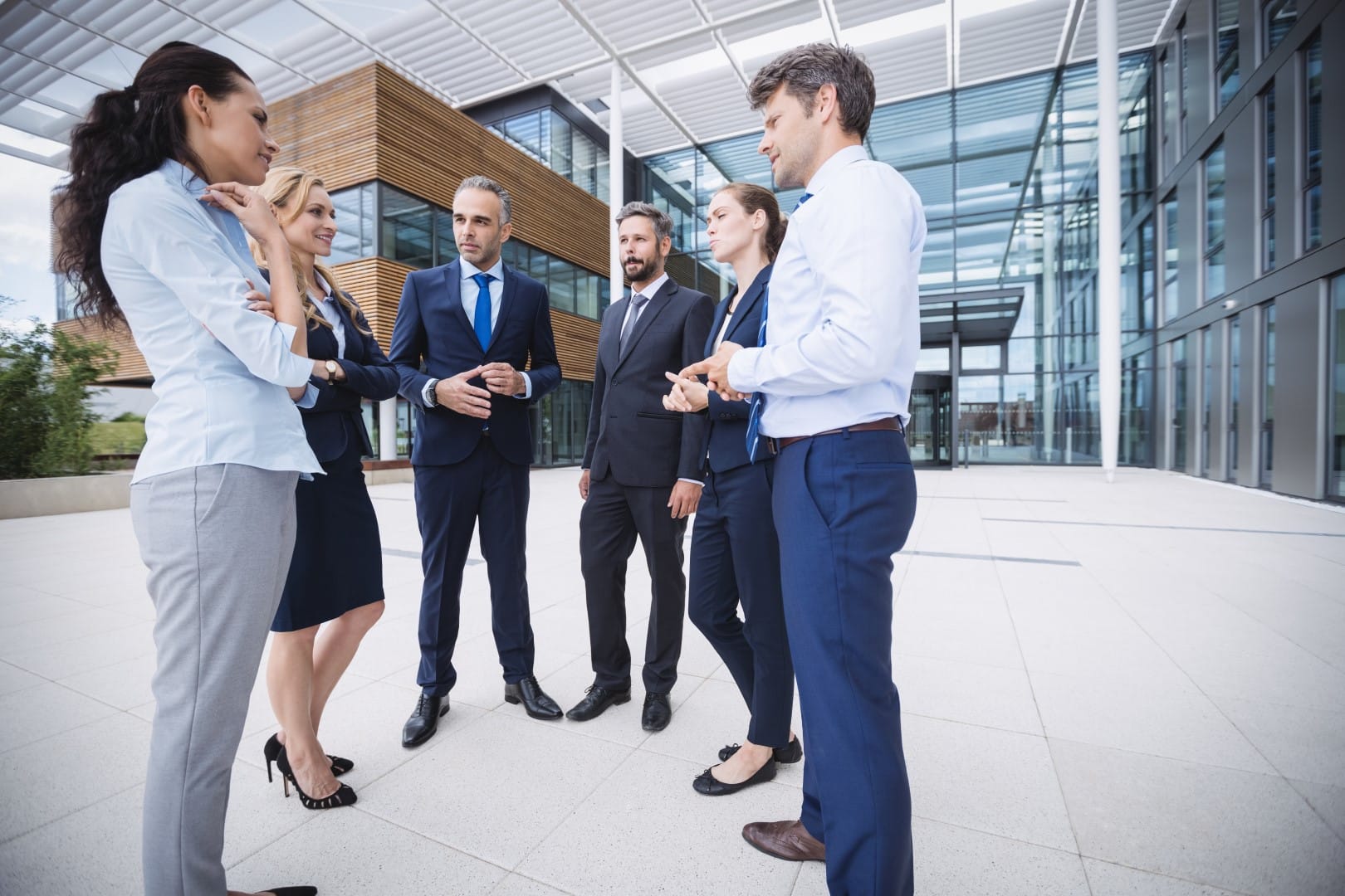 Group of businesspeople interacting outside office building